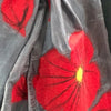 Hand felted red poppy scarf on grey, Close-up